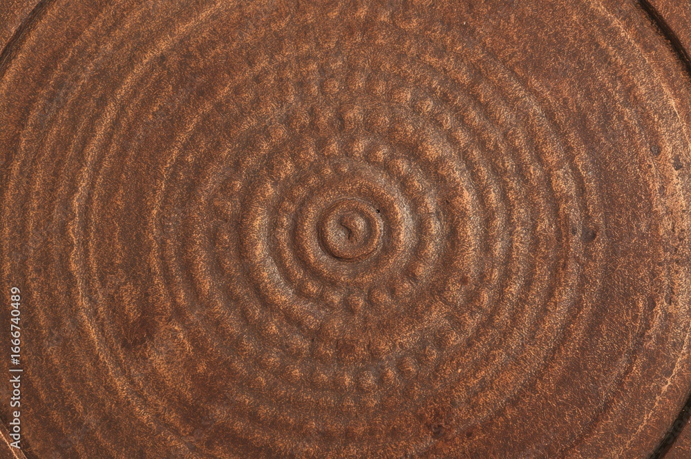 Fototapeta premium Close-up view of a circular, textured surface made of copper.