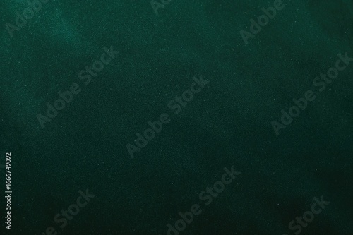 Background of dark green velvet textile with soft, smooth texture and empty space for text.