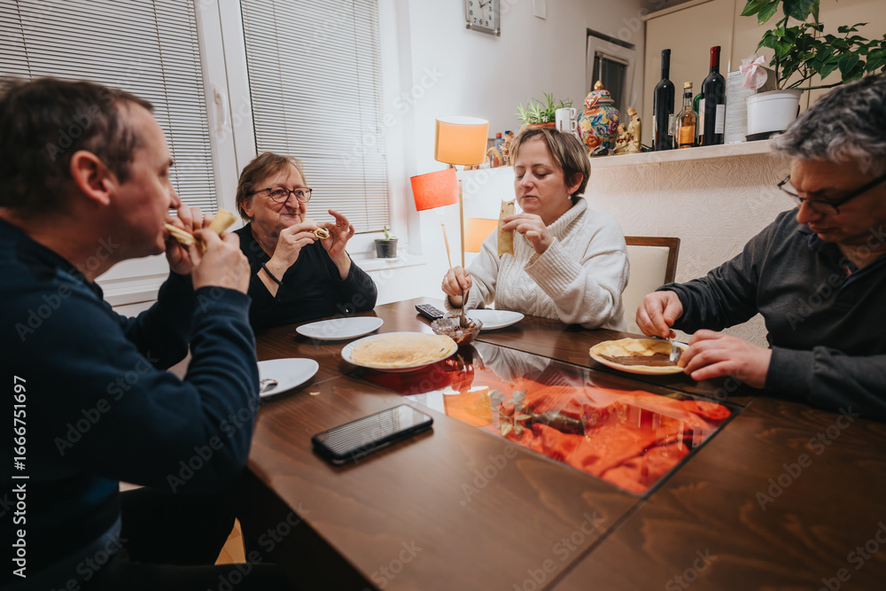 Φωτογραφία A family of four enjoying a meal together at a dinner table, depicting warmth, togetherness, and conviviality in a beautifully arranged home interior