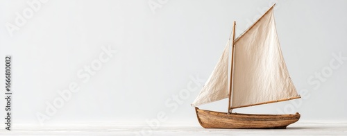 Wooden sailboat on light background