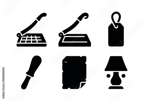 vector solid black filled icons paper cutter (historic): metal trimmer wooden base leather strap worn handle aged paper dim lighting.