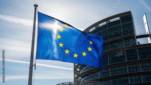 European Union flag waving proudly against the European Parliament building in Strasbourg