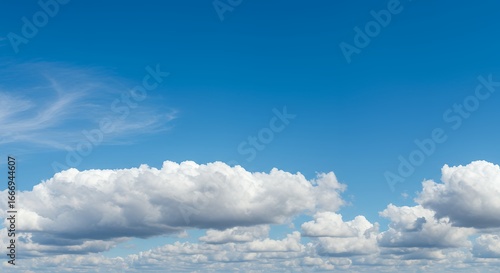 Wallpaper Mural Expansive blue sky with a beautiful band of fluffy white cumulus clouds on a clear and sunny summer day, a serene natural background Torontodigital.ca