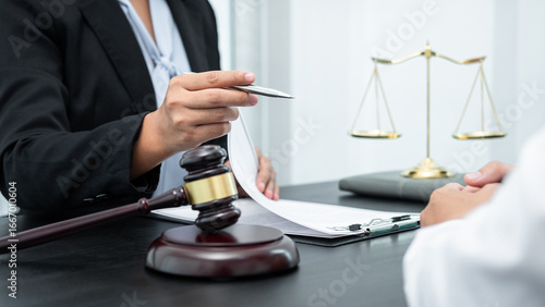 Male lawyer or counselor discussing negotiation legal case with client meeting with document contract in office, law and justice, attorney, lawsuit concept