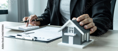 Sale Estate agent giving house model and key to new client after signing agreement contract with approved property form, Home Insurance and Real estate investment concept