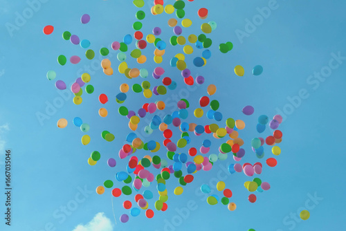 Vibrant balloons soaring into a bright blue sky, perfect for celebrations and joyful moments