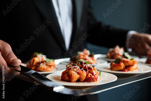 Wallpaper Mural Waiter serving pasta dish from a silver tray Torontodigital.ca