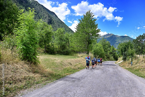 group of boy scouts hiking in the woods on Alps