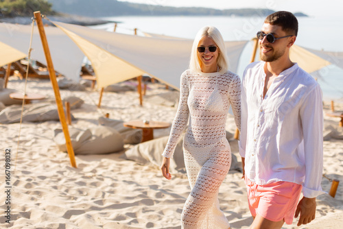 Stylish couple strolling on...