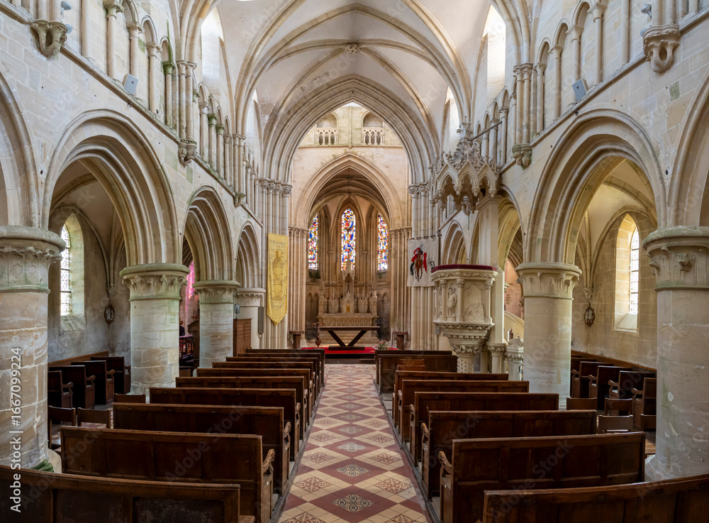 Fototapeta premium Langrune-Sur-Mer, France - 08 05 2025: Panoramic view of the central nave, the pulpit, hangings, the altar and stained glass windows inside the Saint-Martin Church