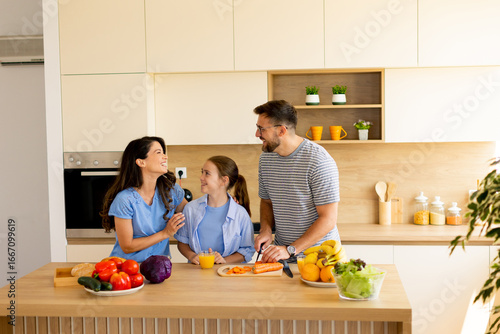 Family enjoys cooking toget...