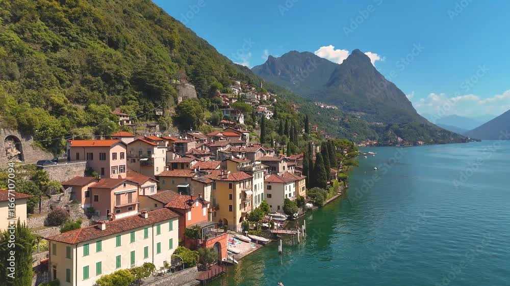 Lake Lugano, Valsolda, Italy. View of the lake, mountains and scenic village. A small Italian town by the lake in Albogasio Oria. Aerial 4K drone video footage Lake Lugano, Valsolda, Italy. View of the lake, mountains and scenic village. A small Italian town by the lake in Albogasio Oria. Aerial 4K drone video footage