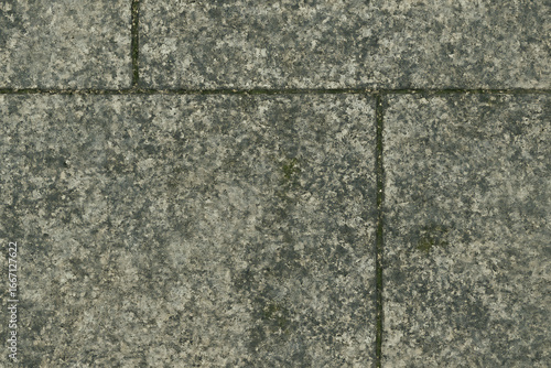 Rough textured stone wall with visible grout lines and subtle color variations