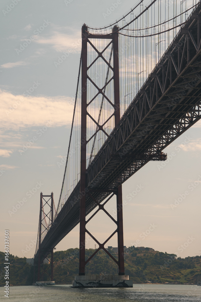 Obraz premium 25 de Abril Bridge Lisbon, Portugal, railway road suspension bridge, engineering huge structure