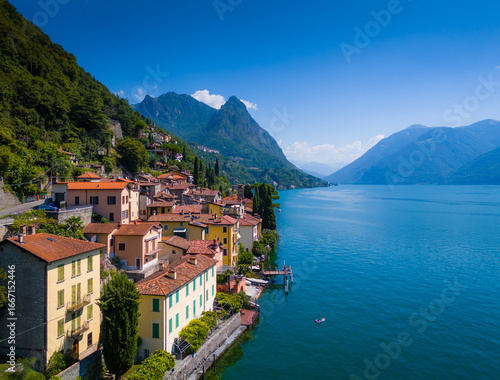 Lake Lugano, Valsolda, Italy. View of the lake, mountains and scenic village. A small Italian town by the lake in Albogasio Oria. Aerial drone view
