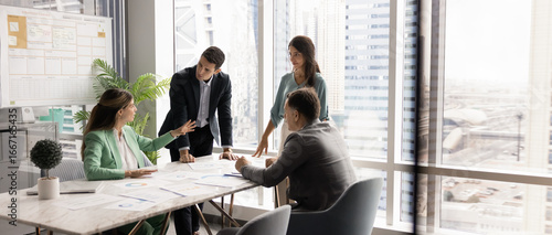 Foto Panoramic image of four professionals negotiating, making decisions in conference room