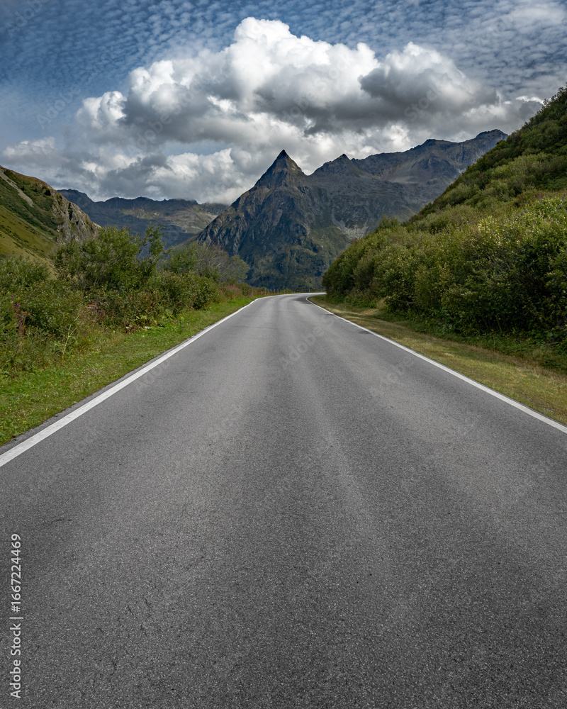 Naklejka premium Mountain road leading to the Alps in Gaschurn, Vorarlberg, Austria