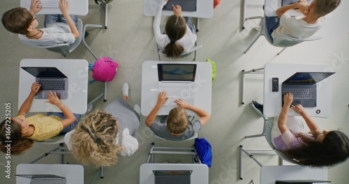 Fotografía Elementary School Children Using Laptops, Creating Drawings During Digital Art Lesson in Classroom