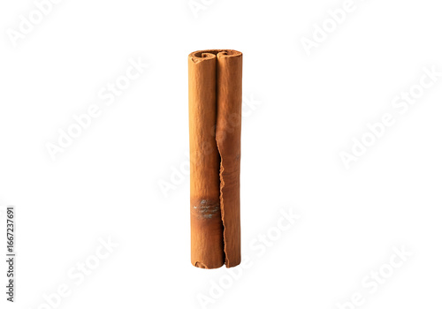 A single cinnamon stick stands out against a stark black background, showcasing its warm, earthy tones and textured surface.