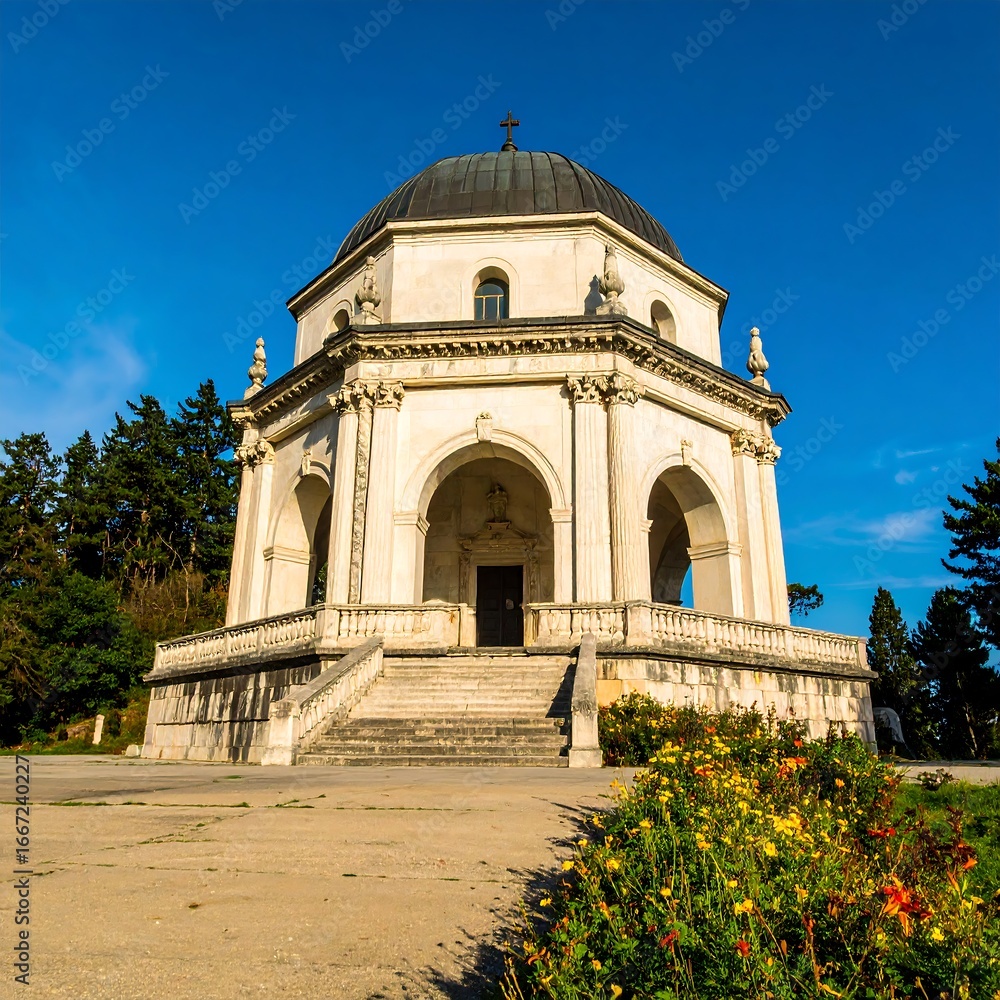 Fototapeta premium Ancient white dome structure, steps, flowers