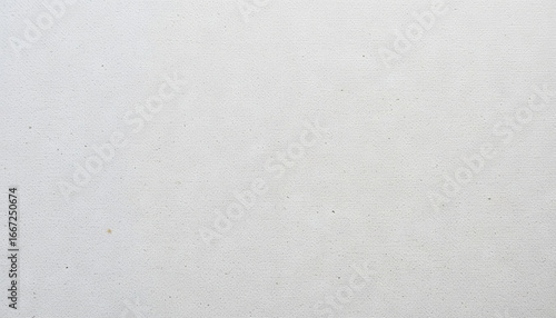 A blank canvas is placed on a clean surface in an artist's studio, waiting for colors and creativity to transform its plainness into a masterpiece. The lighting is soft and inviting