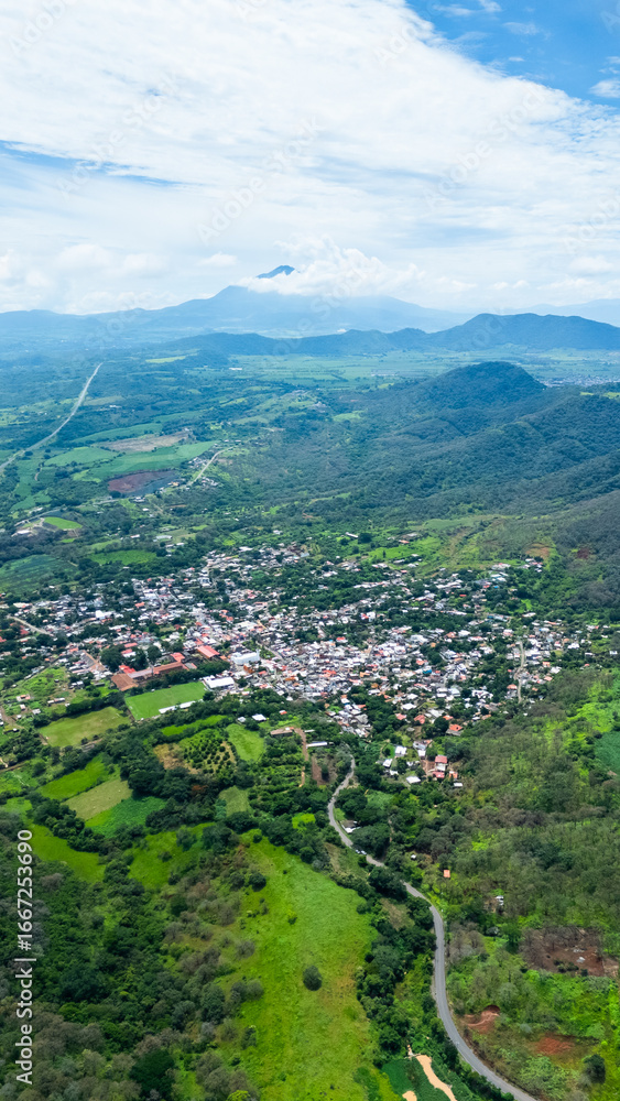 Fototapeta premium Magical neighborhood of Bellavista next to the Tepic highway, and Sanganguey volcano in the background, Mexico