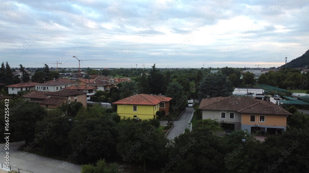 Fototapeta premium Aerial view of the town of Botticino Sera, Brescia, Italy with green fields and from above with a drone