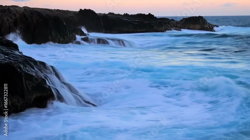 Wallpaper Mural Ocean waves crashing against dark volcanic rock at sunset Torontodigital.ca