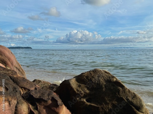 Blue sky with clouds over a tranquil beach, abstract meaning of hope, freedom, and travel inspiration