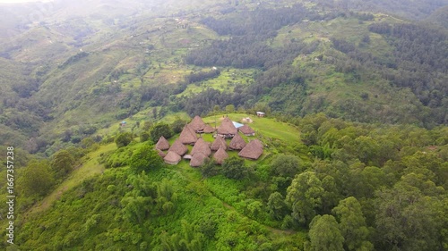 Aerial view of a complex of traditional houses in one of the villages in the Aileu Municipality in Timor Leste located in a hilly area. Still actively inhabited by locals and a tourist attraction.