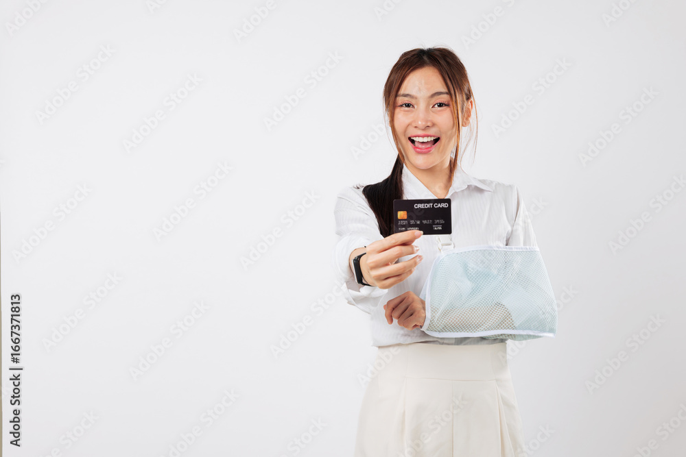 Asian card woman, payment for accident health banking, credit insurance, smiling, she holds her credit card confidently despite broken arm, she has health insurance, isolated studio white background Asian card woman, payment for accident health banking, credit insurance, smiling, she holds her credit card confidently despite broken arm, she has health insurance, isolated studio white background