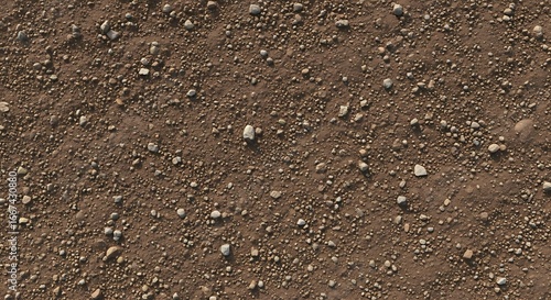 Detailed top-down view of dry, brown earth and soil mixed with small, light-colored pebbles and stones, creating a natural, rough texture background