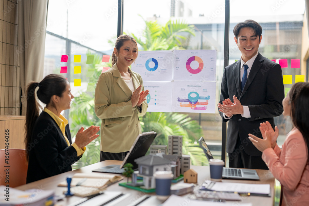 Fototapeta premium Real estate agents clapping after successful business meeting in office