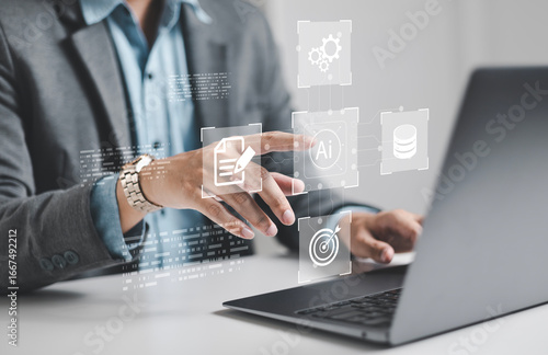 Vászonkép Businessman using laptop to control AI at desk in office
