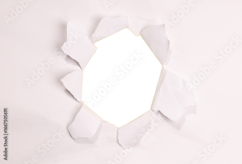 A realistic torn hole in paper with rough edges, isolated on transparent background (PNG). Perfect for design mockups, photo overlays, or creative cutout effects revealing content beneath.