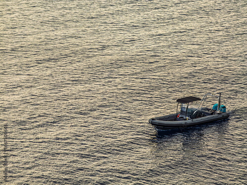 Naklejka premium Rigid Hull Inflatable Boat On Late Sea