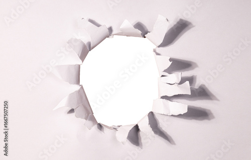 A realistic torn hole in paper with rough edges, isolated on transparent background (PNG). Perfect for design mockups, photo overlays, or creative cutout effects revealing content beneath.