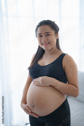 Pregnant asian woman holds hands on belly touching her baby caring about her health Beautiful happy pregnant woman tender mood photo of pregnancy. Free Download Pregnant asian woman holds hands on belly touching her baby caring about her health Beautiful happy pregnant woman tender mood photo of pregnancy. - GFXLoad