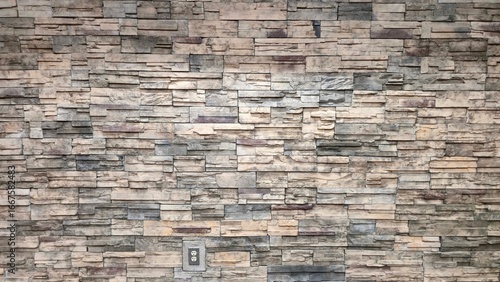 Faux Stone Wall Clad With Stacked Field Stones Contemporary Architecture Professional Building Modern Interior Design Accent Wall Rock Surface Beige and Grey Natural Stone Veneer Installation 