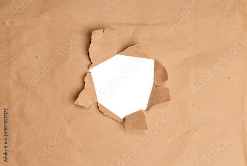 A realistic torn hole in paper with rough edges, isolated on transparent background (PNG). Perfect for design mockups, photo overlays, or creative cutout effects revealing content beneath.