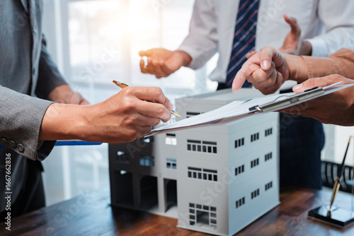 Businessmen signing contract for new industrial building, discussing terms and conditions of agreement
