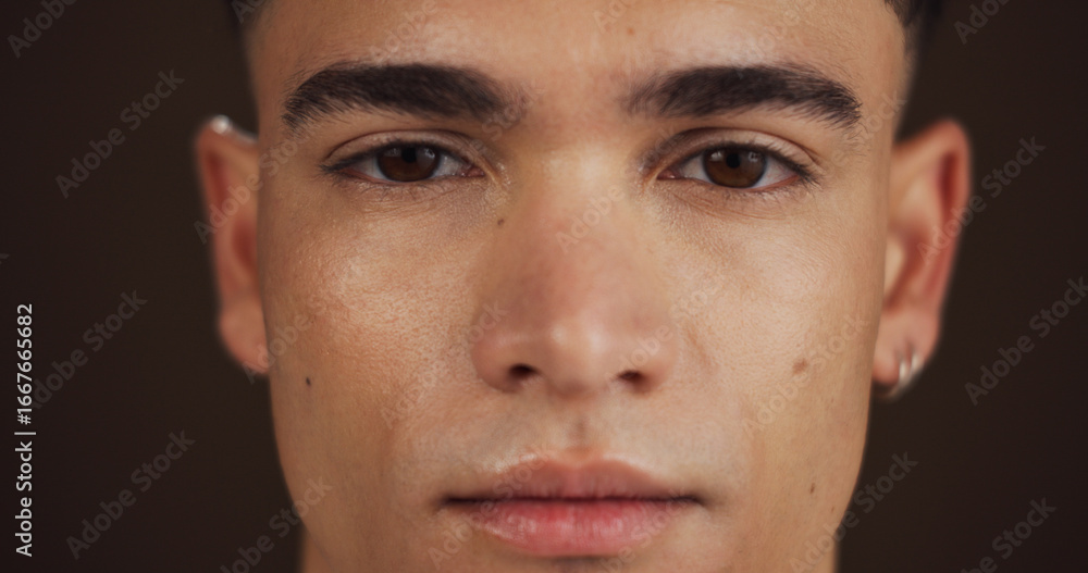 Obraz premium Skincare, beauty and portrait of man in studio with natural, cosmetic and facial glow for confidence. Health, wellness and face of male person from Australia with dermatology by brown background.