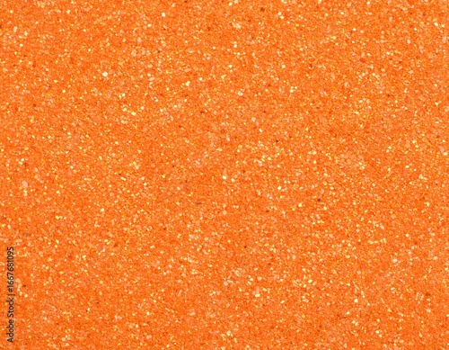 Vibrant orange glitter and sand texture provides a sparkling, festive background.