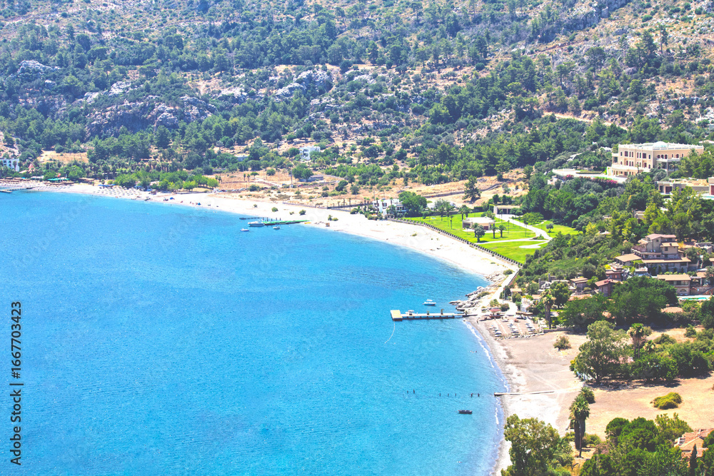 Fototapeta premium Marmaris Amos Bay shores. Blue sea and long beaches. Türkiye's natural beauties concept. Travel. Summer holiday. Top view, above. No people, nobody. Horizontal photo. 