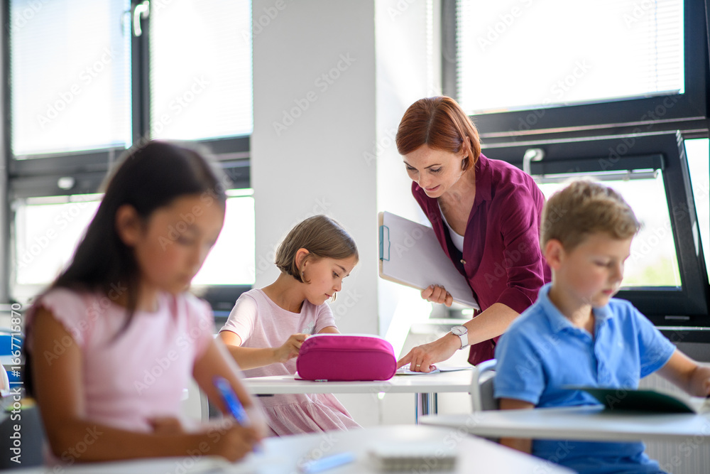 Teacher talking with children in primary class. Teacher talking with children in primary class.
