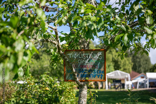 ‘The Listening Game – Close Your Eyes, What Sounds Can You Identify?’ Sign Hanging on Tree in Sweden
