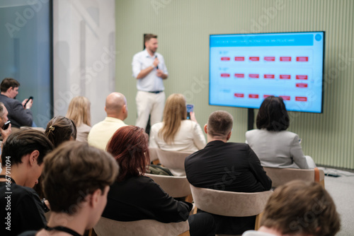 Wallpaper Mural Professional speaker delivering presentation to audience during business seminar with visual aids. Torontodigital.ca