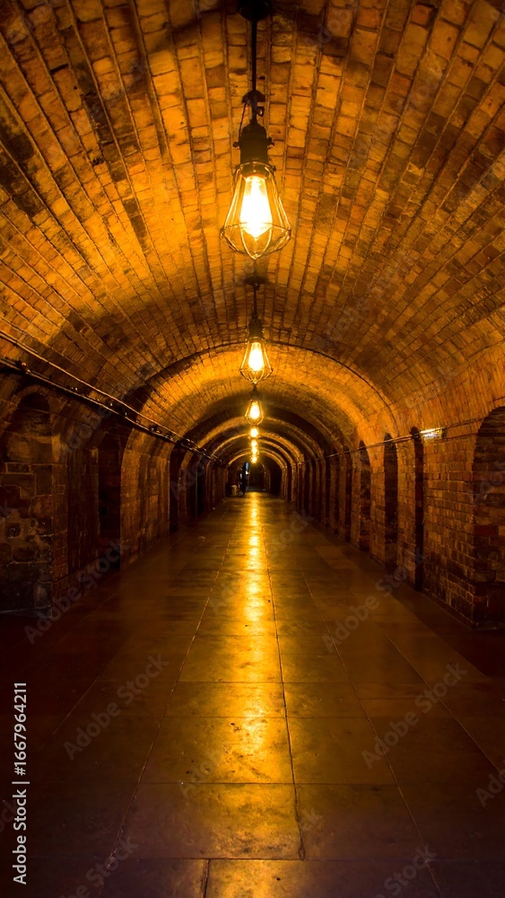 Fototapeta premium Ancient Stone Tunnels, Golden Light, Mysterious Passageway.