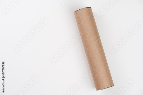 Obraz na plátně Long cardboard tube lying on white background