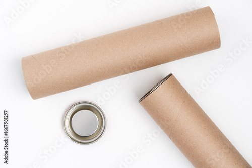 Obraz na plátně Two cardboard tubes with metal lid lying on white background